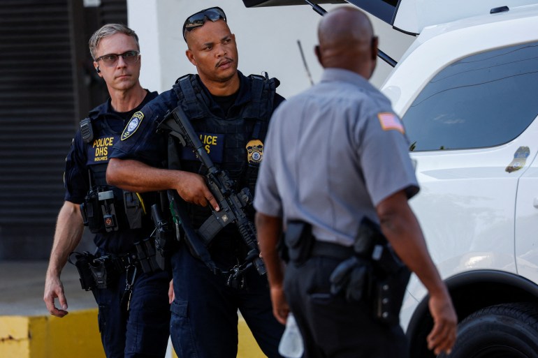 Police officers stand outside the Paul G Rogers Federal Building U.S. Courthouse, ahead of a possible planned court appearance for Ryan W. Routh, the reported suspect in an apparent assassination attempt on Republican presidential nominee and former U.S. President Donald Trump, in West Palm Beach, Florida, U.S. September 16, 2024. REUTERS/Marco Bello