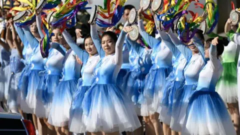 Getty Images Dancers perform as they welcome Zimbabwean President Emmerson Mnangagwa on 2 September 2024 at Beijing Capital International Airport