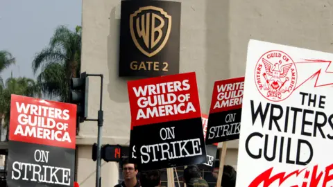 Reuters People stand with signs during Hollywood writer strikes 