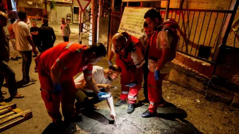 Reuters Palestinian paramedics inspect the scene of an Israeli air strike in Tubas, in the occupied West Bank (11 September 2024)