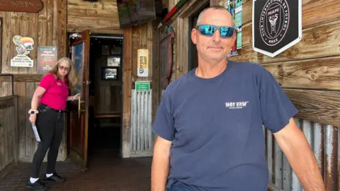 Shelby Stevens standing outside a bar