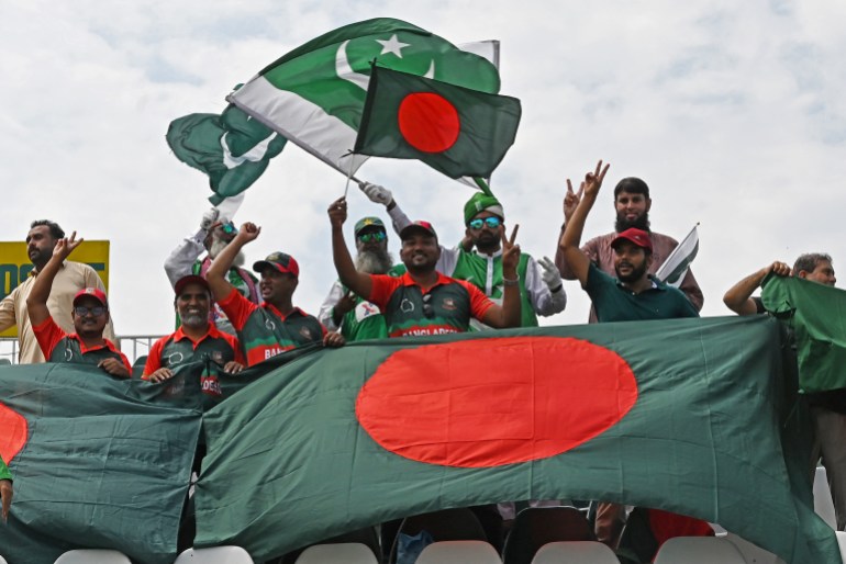 Bangladesh and Pakistan fans wave their national flags as they watch the fifth and final day of the second and last Test cricket match between Pakistan and Bangladesh, at the Rawalpindi Cricket Stadium in Rawalpindi on September 3, 2024. (Photo by Aamir QURESHI / AFP)