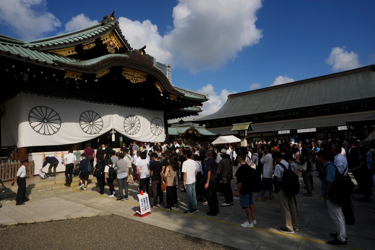 People queue to pray at the Yasukuni shrine in August