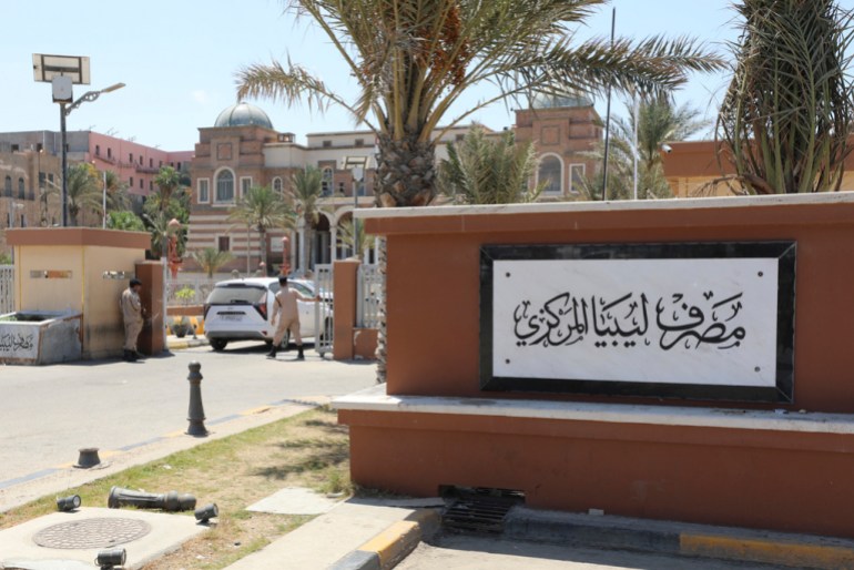 Libyan soldiers guard the gate of the central bank headquarters in Tripoli