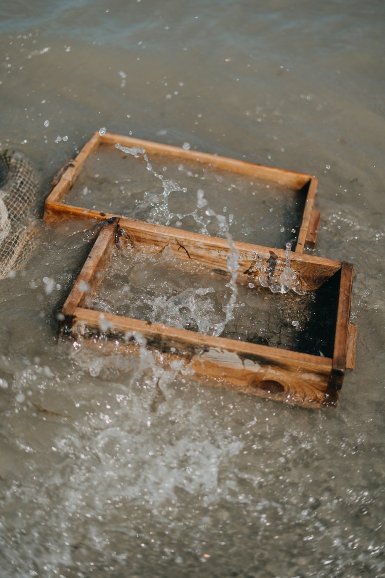 Fishing equipment is rinsed in the waters of the North Sea in Oostduinkerke, Belgium in July 2024. Photo by Diana Takacsova.