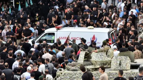 Getty Lebanese army soldiers stand guard as an ambulance arrives after a reported device explosion occurred during the funeral of people killed when hundreds of paging devices exploded in a deadly wave across Lebanon the previous day, in Beirut's southern suburbs on September 18, 2024. 