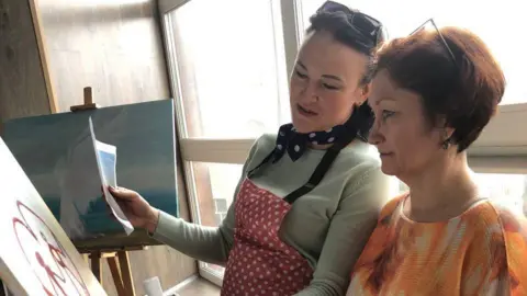 Maria Ivashchenko Maria paints with an Ukrainian woman