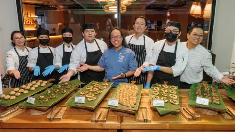 Insects to Feed the World Nicholas Low (third from right) and Joseph Yoon (fourth from right) led the team that prepared the cricket buffet for Insects to Feed the World participants