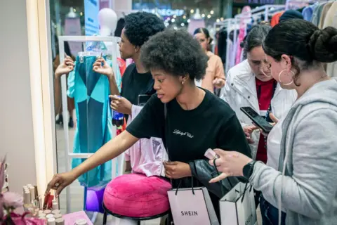 Getty Images Customers try make-up at the Shein pop-up store in Mall of Africa on in Johannesburg, South Africa - August 2024