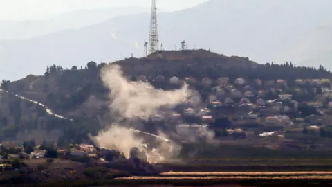 AFP Smoke rises from the northern Israeli town of Metula following a Hezbollah rocket attack, as seen from the southern Lebanese area of Marjayoun (31 October 2024)