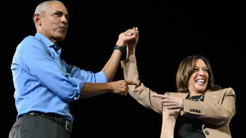 Getty Images Barack Obama and Kamala Harris embrace ahead of her keynote speech in Georgia on Thursday night