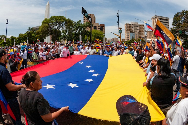 People carry Venezuela's flag as they protest election results.