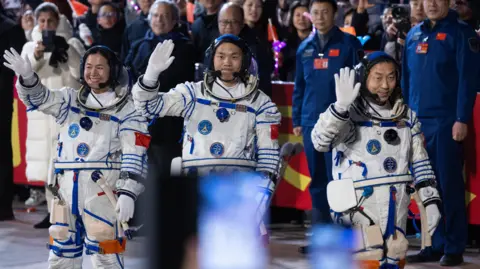 EFE Astronauts (from left to right) Wang Haoze, Song Lingdong and Cai Xuzhe walk to the car that will take them to the site of the Shenzhou-19 Manned Spaceflight Mission near Jiuquan in Gansu Province