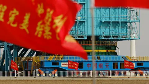 BBC/ Xiqing Wang The base of the rocket encased in blue scaffolding