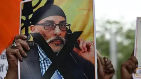 Getty Images Photo of a man holding an image of Sikh separatist leader Gurpatwant Singh Pannun