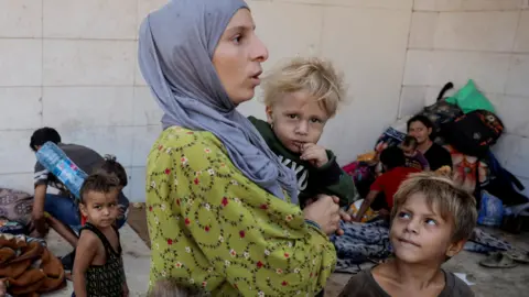 Reuters A displaced family from Dahiyeh, a southern Beirut suburb, shelter on a street in central Beirut, Lebanon (29 September 2024)