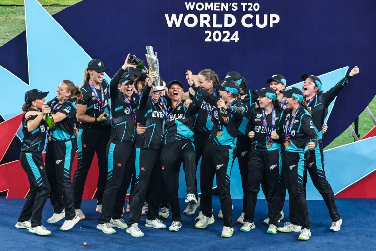 New Zealand's players celebrate with their winning trophy at the end of the ICC Women's T20 World Cup cricket final match between South Africa and New Zealand at the Dubai International Cricket Stadium in Dubai on October 20, 2024. (Photo by FADEL SENNA / AFP)