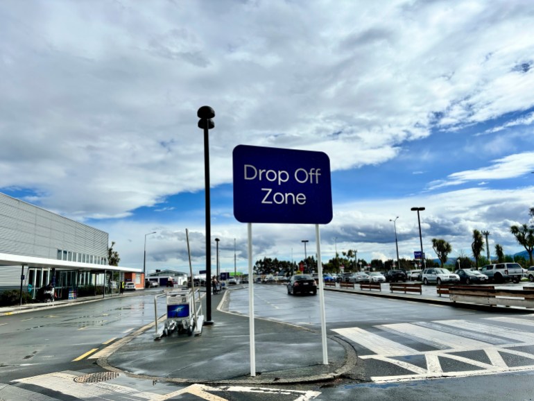 A sign for the drop off area is displayed at the Dunedin airport in Momona, New Zealand