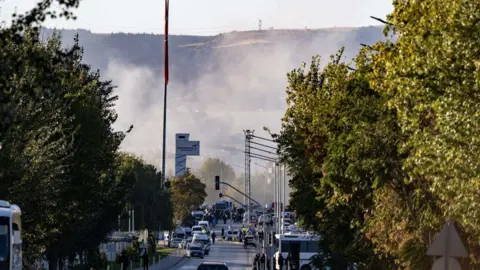 Getty Images Smoke rising above a street near the site of the explosion outside Turkish Aerospace Industries in Ankara