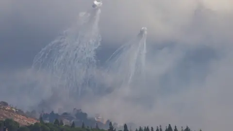 Reuters Structures in southern Lebanon are hit by Israeli artillery fire, as seen from Kiryat Shmona, northern Israel (1 October 2024)