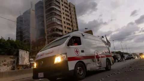 Getty Images An ambulance at an apartment hit by an Israeli airstrike in Beirut. Lebanese healthcare officials say ambulances and hospitals have been hit by direct Israeli airstrikes.  