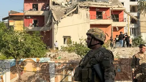 Reuters A Lebanese army soldier stands in front of ruined building in the city of Sidon, southern Lebanon