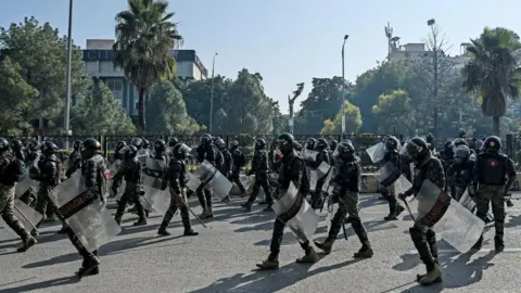 AFP Paramilitary soldiers march along a street leading to the Red Zone area during a protest by the supporters of the Pakistan Tehreek-e-Insaf (PTI) party