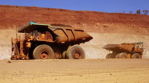 Zoe Corbyn Two huge mining trucks pass by each other in a mine in Western Australia