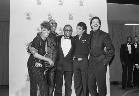 Getty Images Dionne Warwick, Stevie Wonder, Quincy Jones, Michael Jackson, and Lionel Richie congratulate each other after We Are The World wins four Grammy Awards in 1986