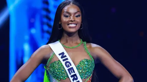 Getty Images Chidimma Adetshina, wearing a shiny green bra-top and a Miss Nigeria sash at the Miss Universe competition in Mexico City on November 16, 2024