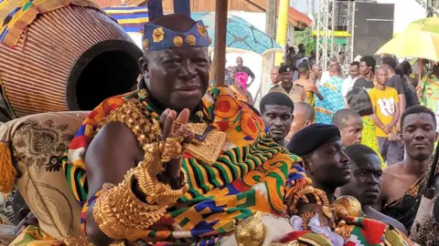 Barnaby Phillips King Osei Tutu II is paraded on his palanquin through the crowd, weighed down by magnificent gold jewellery