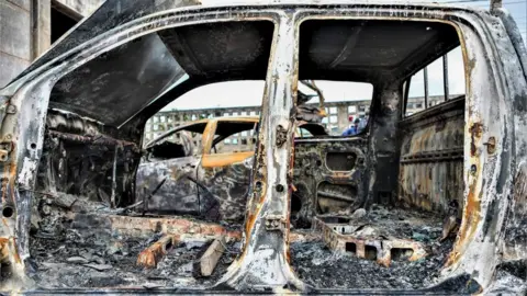 EPA Burnt cars after violent demonstrations contesting the results of the 9 October general elections, in Maputo, Mozambique, 08 November 2024