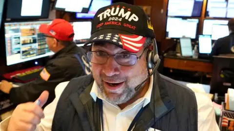 Getty Images A trader wears a Trump hat as he works on the floor of the New York Stock Exchange