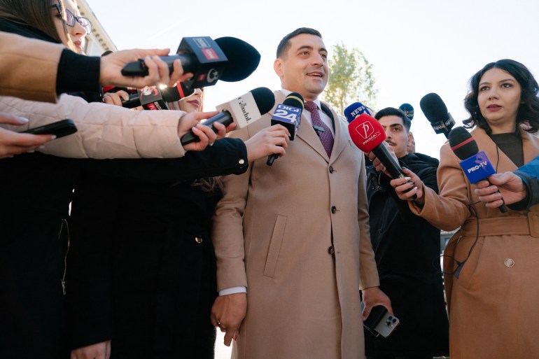 Presidential candidate and leader of the far-right Alliance for the Unity of Romanians AUR party, George Simion, addresses the press outside a polling station in Bucharest, Romania, on November 24, 2024, [Andrei Pungovschi / AFP]