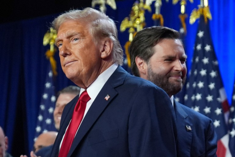 Republican presidential nominee former President Donald Trump and his running mate Sen. JD Vance, R-Ohio, stand on stage at an election night watch party at the Palm Beach Convention Center, Wednesday, Nov. 6