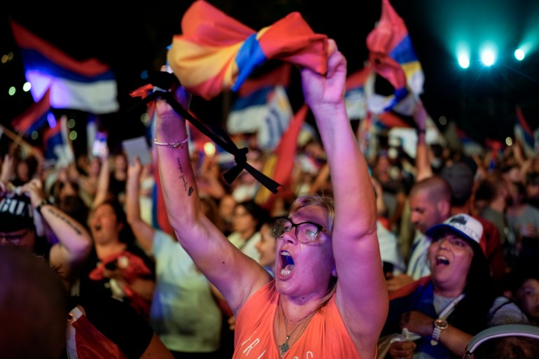 Supporters wave flags in Montevideo as Yamandu Orsi surges ahead in the polls.