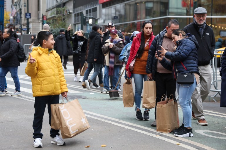 Shoppers take photos outside Macy's Herald Square, in NYC, US