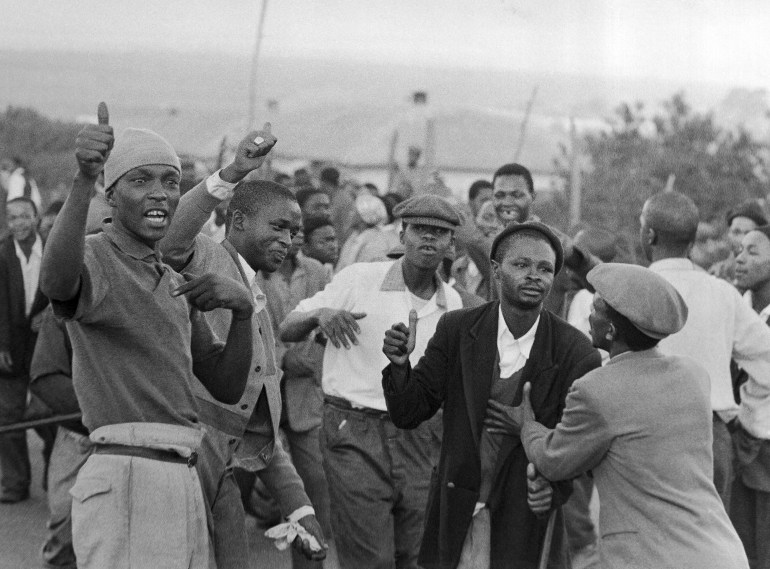 Young Blacks in foreground jeer at passing police in Orlando Township, near Johannesburg, Monday, April 1, 1960 during ?Day of Mourning,? for the victims of the Sharpeville shootings. Protest for the shooting of 80 persons over the racial restrictions spread to a large area of the country. (AP Photo)