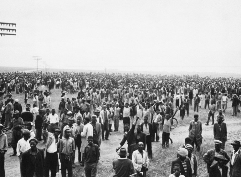 A crowd gathers at the township of Sharpeville, south of Johannesburg, South Africa, March 21, 1960, a few hours before white police opened fire on them with bren-guns. They were demonstrating against the law requiring Africans to carry passes. Sixty Africans were killed and hundreds injured in the shooting. (AP Photo/ Cape Argus)