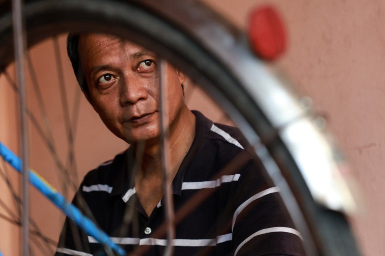 Zaw Gyi, 46, a Myanmar regime defector, is portrayed during an e-bike and bicycle repair workshop near the Thailand-Myanmar border on November 1, 2024 [Valeria Mongelli/Al Jazeera]