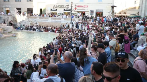 Getty Images  People visit the Trevi Fountain in Rome, Italy