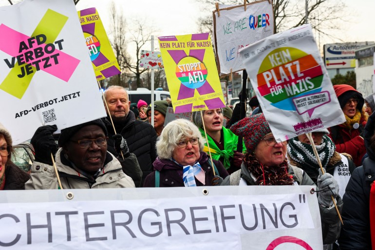 People hold signs as they protest outside an Alternative for Germany party (AfD) event where co-chairwoman Alice Weidel is expected to be nominated as AfD candidate for Chancellor for the upcoming general elections in Berlin, Germany December 7,