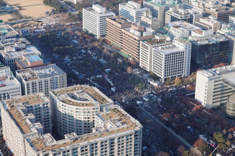 Protesters participate in a rally calling for the impeachment of South Korean President Yoon Suk Yeol, who declared martial law, which was reversed hours later, in front of the National Assembly in Seoul, South Korea, December 14, 2024. REUTERS/Kim Soo-hyeon