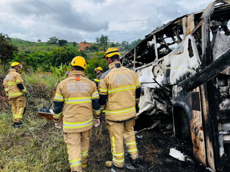 Firefighters attend to a traffic accident after a packed bus collided with a truck, at the Fernao Dias national highway, near Teofilo Otoni, Brazil