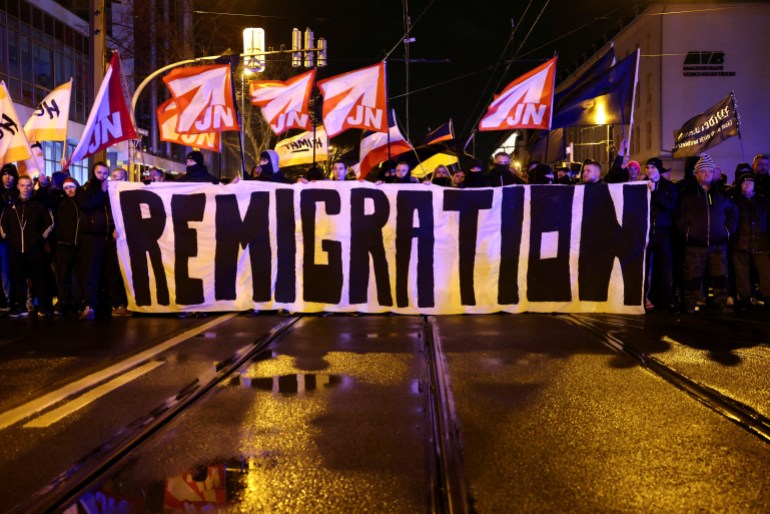 Far-right demonstrators take part in a protest after a car drove into a crowd at a Christmas market