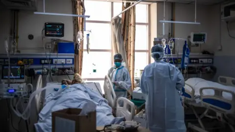 Getty Images Medical staff attend to Covid-positive patients in the ICU ward at the Holy Family hospital on May 06, 2021 in New Delhi, India. 