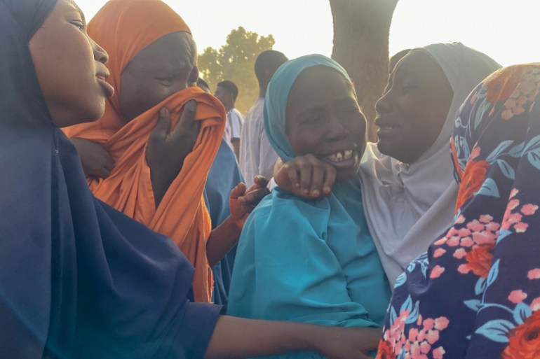 Women react as children, who were released after being kidnapped by gunmen in Kuriga, are reunited with their families in Kuriga on March 28, 2024. Over 130 Nigerian schoolchildren freed following a mass kidnapping have reunited with their families on March 28, 2024, a state governor's spokesperson told AFP.