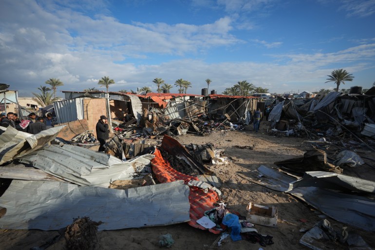 A doll lies among plastic debris and clothes in the aftermath of an Israeli airstrike