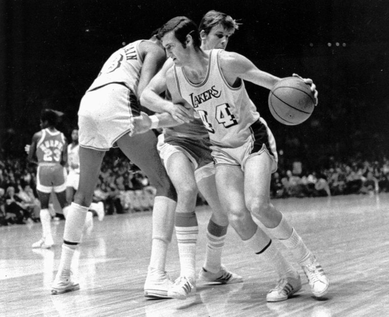 Basketball player dribbling the ball on court.