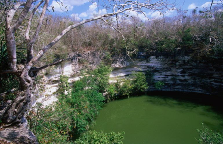 Chichen's Sacred Cenote, a natural well used by the ancient Mayans in religious ceremonies. - stock photoChichen Itza, Yucatan, Mexico, North America